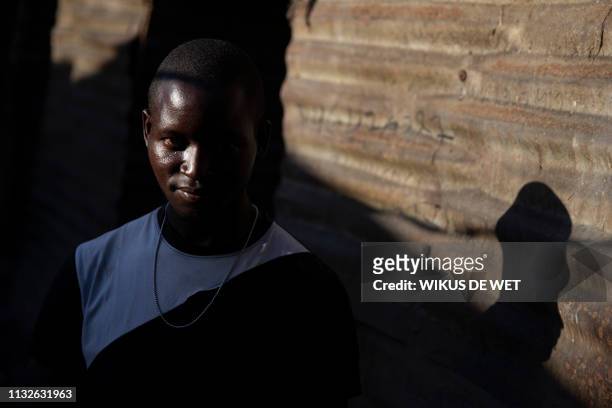 Zacaria Machangu, whose house was partly damaged, poses for a portrait outside his damaged house in the Praia Move area in Beira, Mozambique on March...