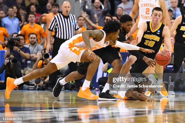 Isaiah Moss and Joe Wieskamp of the Iowa Hawkeyes fight for a rebond against Jordan Bowden and Kyle Alexander of the Tennessee Volunteers in the...