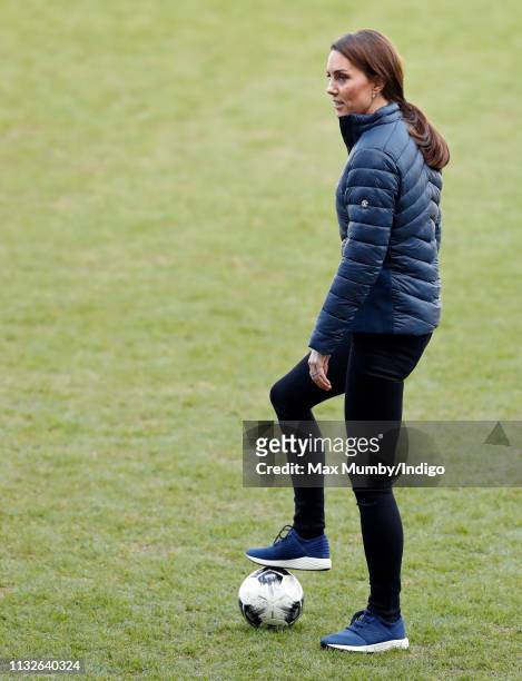 Catherine, Duchess of Cambridge plays football during a visit to Windsor Park Stadium, home of the Irish Football Association on February 27, 2019 in...