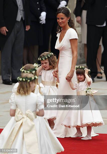 Sister of the bride and Maid of Honour Pippa Middleton holds hands with Grace Van Cutsem and Eliza Lopes as they arrive to attend the Royal Wedding...