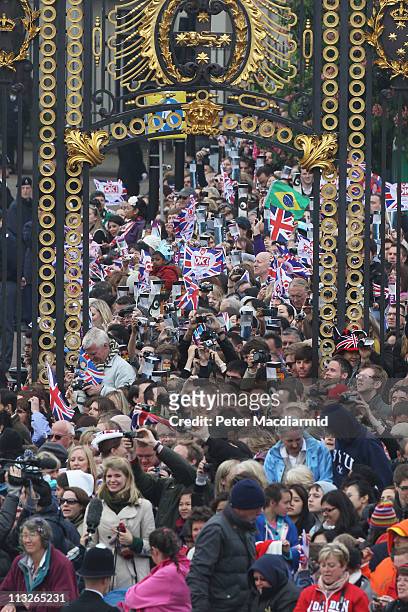 Crowd of spectators take photographs near to Buckingham Palace prior to the Royal Wedding of Prince William to Catherine Middleton at Westminster...