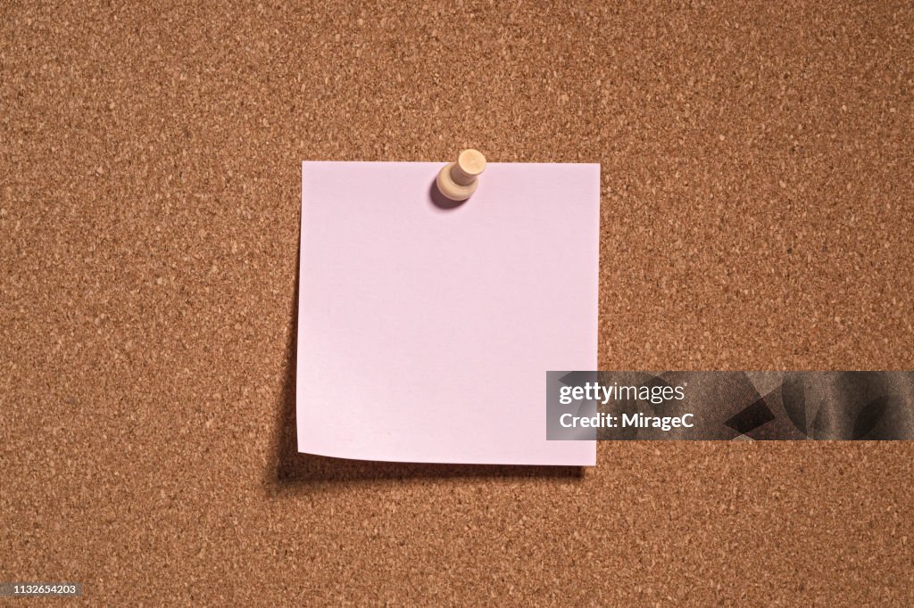 Pink Colored Note Paper on Cork Board