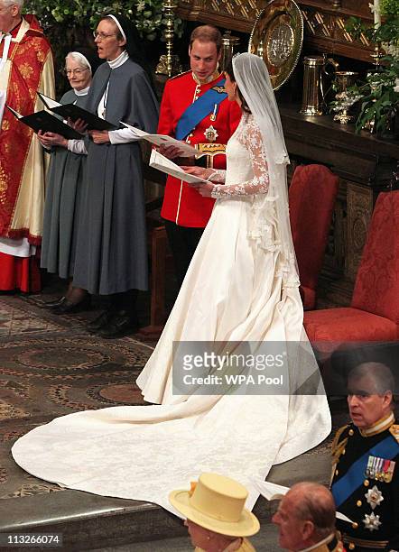 Prince William and Catherine Middleton sing during their wedding service in Westminster Abbey on April 29, 2011 in London, England. The marriage of...
