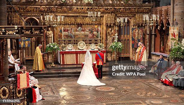 Prince William and his new bride Catherine Middleton stand in front of the altar during the service on April 29, 2011 in London, England. The...