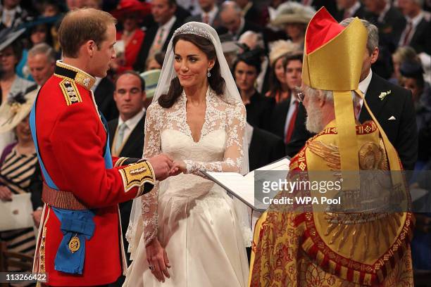 Prince William exchanges rings with his bride Catherine Middleton in front of the Archbishop of Canterbury, Rowan Williams inside Westminster Abbey...