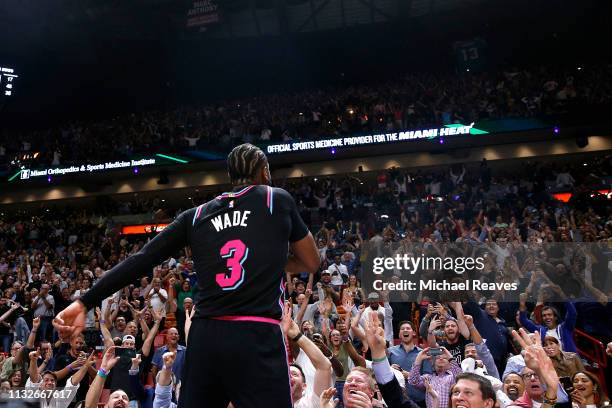 Dwyane Wade of the Miami Heat celebrates after hitting a game-winning three pointer against the Golden State Warriors at American Airlines Arena on...