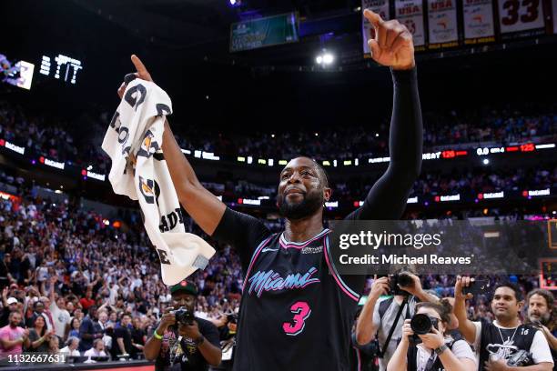 Dwyane Wade of the Miami Heat celebrates after hitting a game-winning three pointer against the Golden State Warriors at American Airlines Arena on...