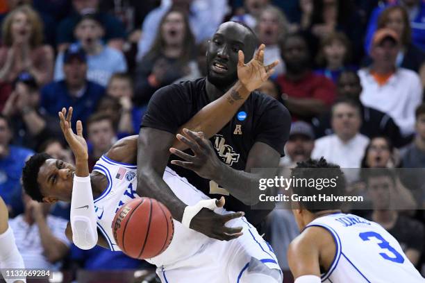 Barrett of the Duke Blue Devils and Tacko Fall of the UCF Knights compete for the ball in the second round of the 2019 NCAA Photos via Getty Images...