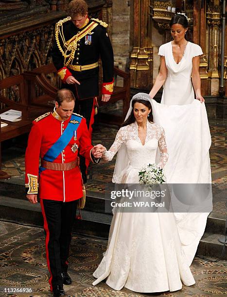Prince William takes the hand of his bride Catherine Middleton, now to be known as Catherine, Duchess of Cambridge, followed by Prince Harry and...