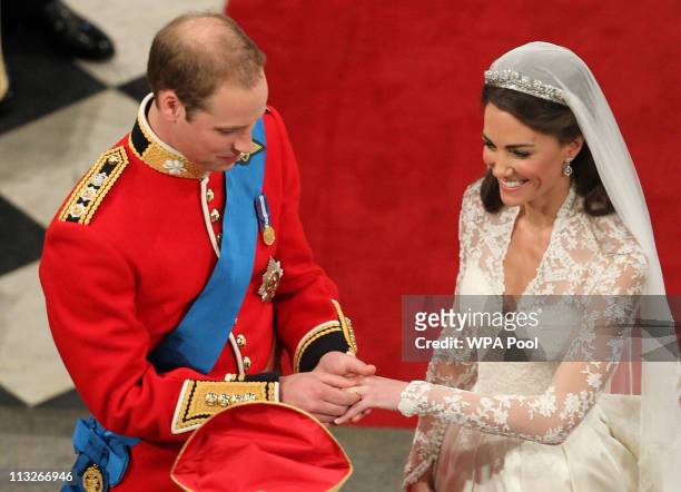 Prince William exchanges rings with his bride Catherine Middleton in front of the Archbishop of Canterbury, Rowan Williams inside Westminster Abbey...