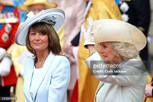 Carole Middleton smiles as Camilla, Duchess of Cornwall waves to the cheering crowds following the marriage of Prince William, Duke of Cambridge and...