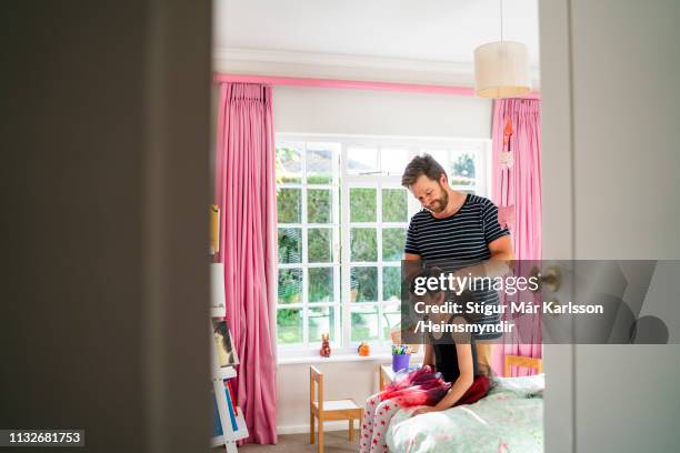 father tying daughter's hair in bedroom at home - girl dressing up stock pictures, royalty-free photos & images