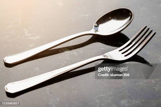 close up spoon of fork isolated over white background with a little shadow - forchetta foto e immagini stock