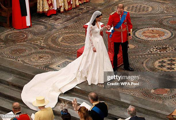 Prince William takes the hand of his bride Catherine Middleton, now to be known as Catherine, Duchess of Cambridge, as they walk down the aisle...