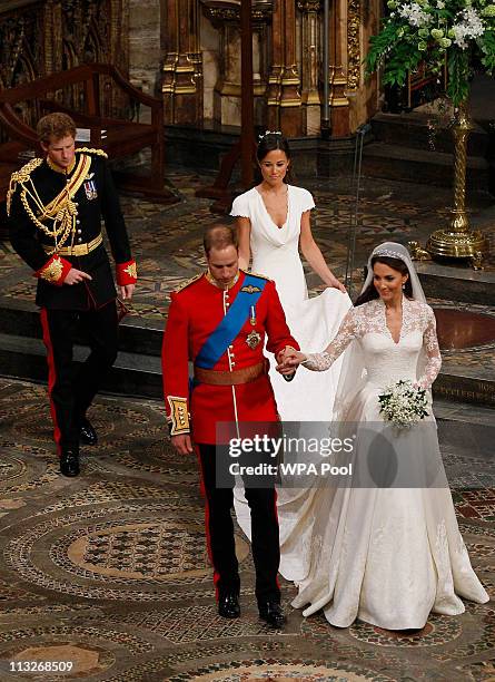 Prince William takes the hand of his bride Catherine Middleton, now to be known as Catherine, Duchess of Cambridge, as they walk down the aisle...