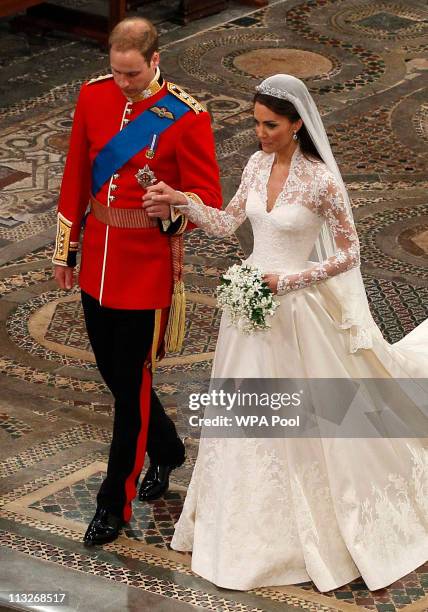 Prince William takes the hand of his bride Catherine Middleton, now to be known as Catherine, Duchess of Cambridge, as they walk down the aisle...