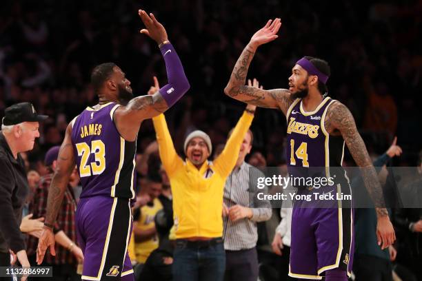 LeBron James of the Los Angeles Lakers celebrates with Brandon Ingram after making a three-pointer against Jrue Holiday of the New Orleans Pelicans...