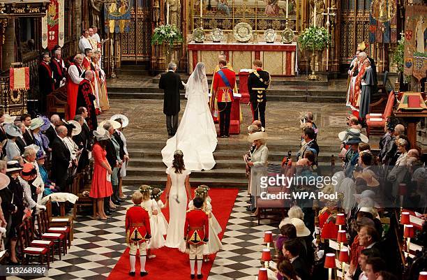 Prince William and his new bride Catherine Middleton stand side by side at the beginning of their wedding ceremony at Westminster Abbey on April 29,...