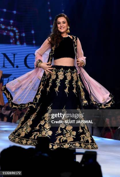 Indian Bollywood actress Preity Zinta displays a creation by designer Shaina NC during the 14th annual Caring with Style fashion show in association...
