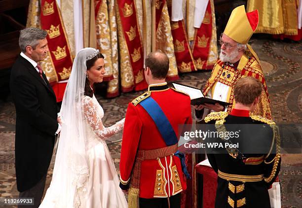 Prince William and Catherine Middleton are seen at the altar with Archbishop of Canterbury Rowan Williams , Prince Harry and father of the bride...