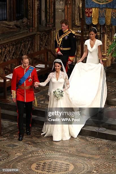 Prince William, Duke of Cambridge and his new bride Catherine, Duchess of Cambridge walk down the aisle followed by best man Prince Harry and Maid of...