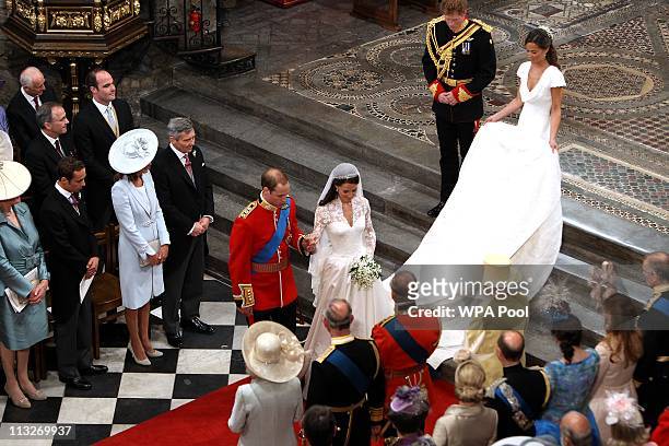 Prince William, Duke of Cambridge and his new bride Catherine, Duchess of Cambridge bow to Queen Elizabeth II at the close of their wedding ceremony...