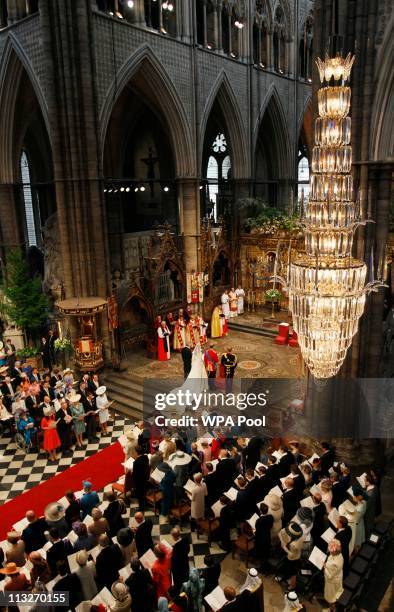 Prince William, and Catherine Middleton with Michael Middleton and Prince Harry stand at the altar during the Royal Wedding of Prince William to...