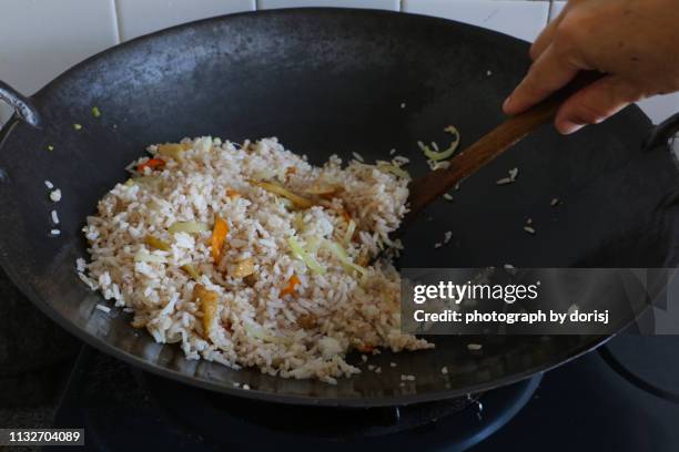 fried rice on wok - fried rice stock-fotos und bilder