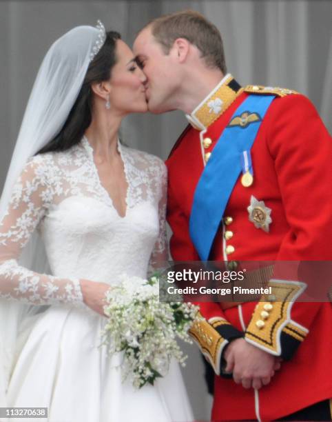 Prince William, Duke of Cambridge and Catherine, Duchess of Cambridge kiss on the balcony at Buckingham Palace on April 29, 2011 in London, England.