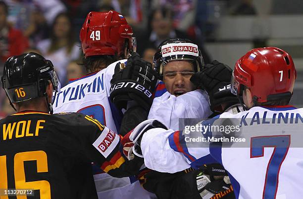 Kai Hospelt of Germany is blocked by Vitali Atyushov and Dmitri Kalinin of Russia battle for the puck during the IIHF World Championship group A...