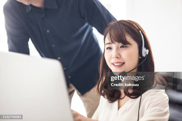 a woman whose manager is instructing the support content woman customer support - telephone worker stock pictures, royalty-free photos & images