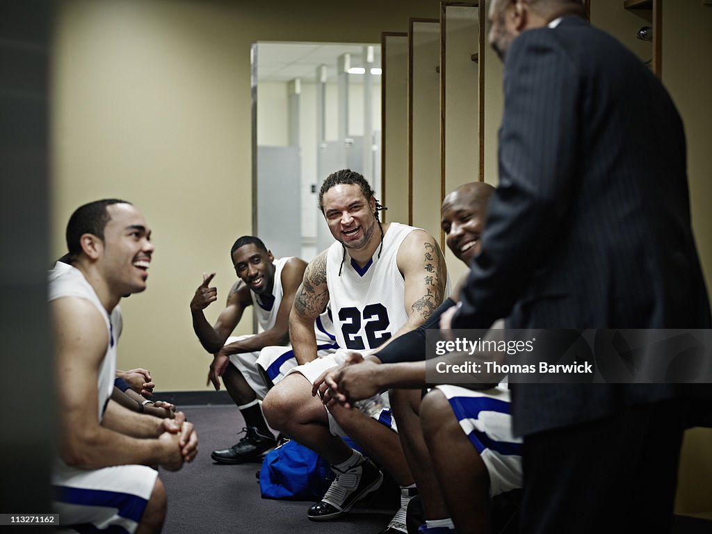 Basketball team in locker room with coach
