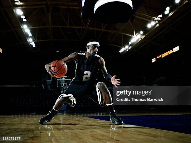 basketball player dribbling basketball on court - dribbling sport foto e immagini stock