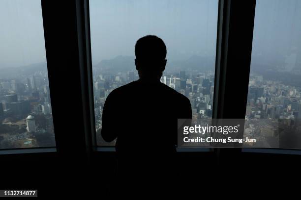 Man looks central Seoul through a window at the N Seoul Tower on February 28, 2019 in Seoul, South Korea. U.S President Donald Trump and North Korean...