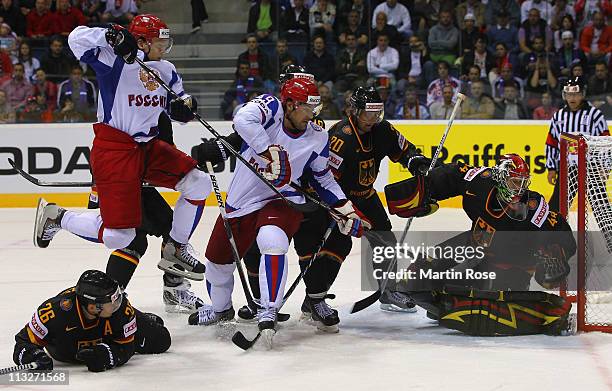 Dennis Endras , goaltender of Germany saves the shot of Yevgeni Artyukhin of Russia battle for the puck during the IIHF World Championship group A...