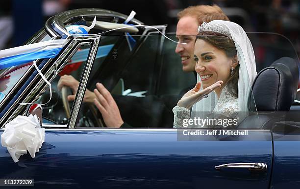 Prince William, Duke of Cambridge and Catherine, Duchess of Cambridge drive from Buckingham Palace in a decorated vintage Aston Martin sports car on...