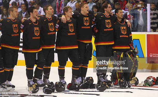 The team of Germany celebrate after the IIHF World Championship group A match between Germany and Russia at Orange Arena on April 29, 2011 in...
