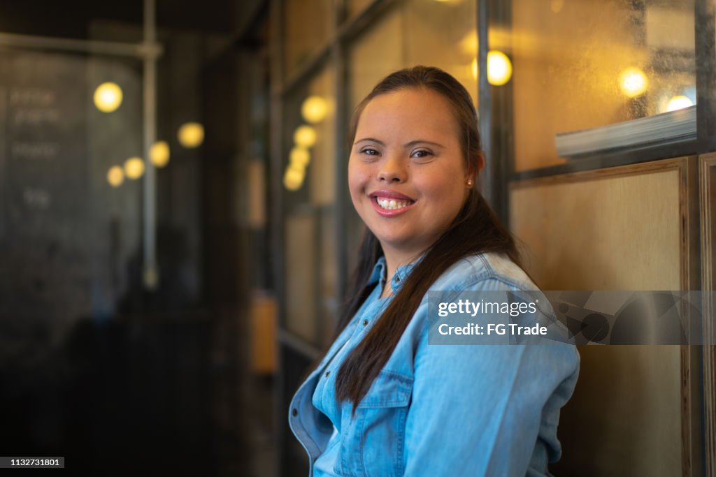 Young woman with special needs in the office portrait - business environment