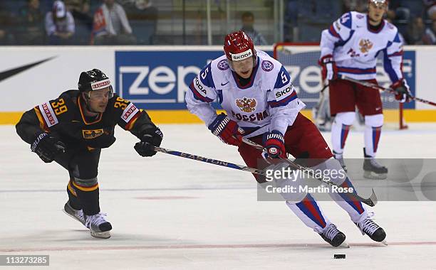 Thomas Greilinger of Germany and Ilya Nikulin of Russia battle for the puck during the IIHF World Championship group A match between Germany and...