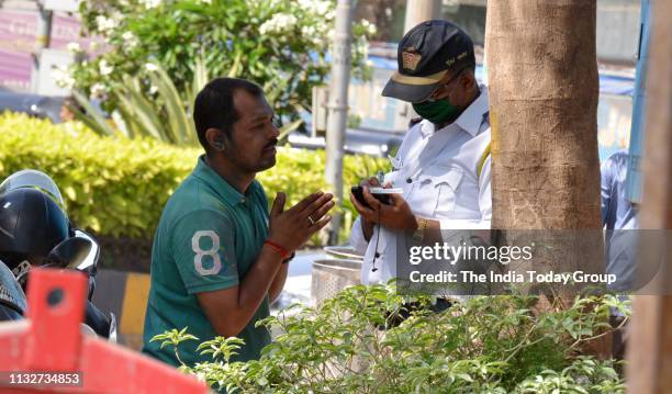 Person clicked while apologizing to traffic police officer for drinking and driving on Holi at Juhu in Mumbai.