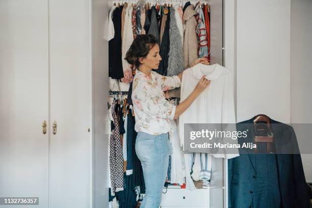 woman getting ready for work - kleiderschrank frau stock-fotos und bilder