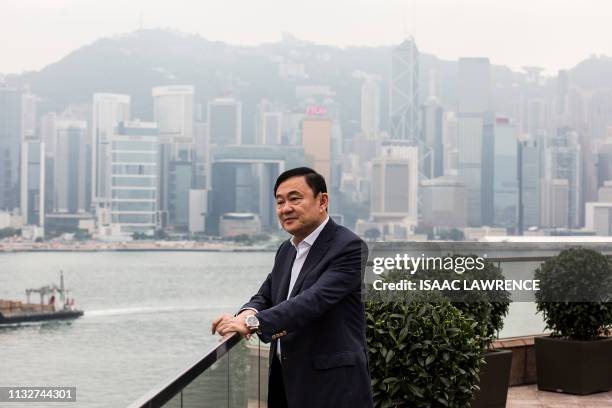 This picture taken on March 25 shows exiled former Thai prime minister Thaksin Shinawatra posing for a portrait after being interviewed by Agence...