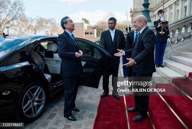 French Foreign Minister Jean-Yves Le Drian welcomes Chinese Foreign Minister Wang Yi at a Franco Chinese seminar of global governance in Quai...