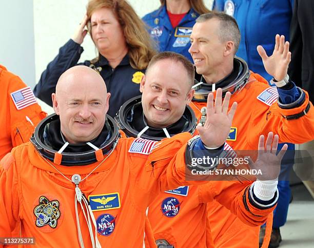 The space shuttle Endeavour Commander Mark Kelly , mission specialists Greg Chamitoff and Andrew Feustel wave as they and fellow astronauts leave...