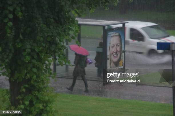 traffic in the rain - bus stop stock pictures, royalty-free photos & images
