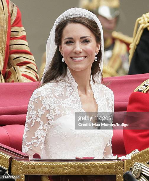 Catherine, Duchess of Cambridge travels down The Mall on route to Buckingham Palace in a horse drawn carriage following her wedding at Westminster...