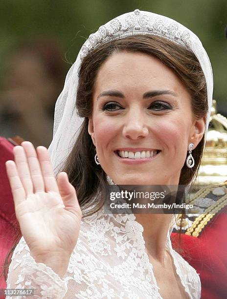 Catherine, Duchess of Cambridge travels down The Mall on route to Buckingham Palace in a horse drawn carriage following her wedding at Westminster...