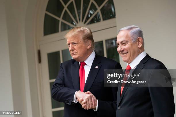 President Donald Trump and Prime Minister of Israel Benjamin Netanyahu shake hands while walking through the colonnade prior to an Oval Office...