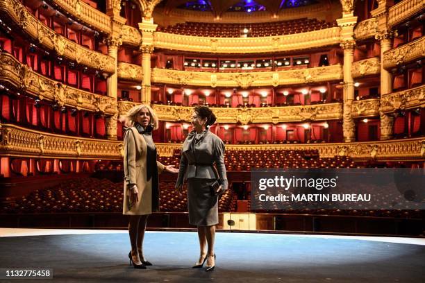 French president's wife Brigitte Macron and Chinese president's wife Peng Liyuan visit the Palais Garnier opera house in Paris on March 25 as part of...