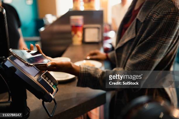 using contactless to pay - contactless payment stock pictures, royalty-free photos & images